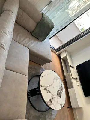 a living room with a table and a couch at Kuc-kuc Twin towers in Becici