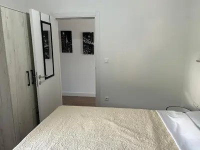 a bedroom with a bed and an open door at Kuc-kuc Twin towers in Becici