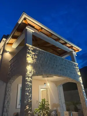 a house with an arched entryway at night at Villa Maluso in Budva