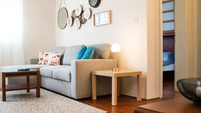 a living room with a couch and a table at Stylish 1 Bedroom Apartment Budva in Budva