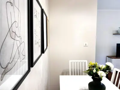 a dining room with a vase of flowers on a table at Stylish 1 Bedroom Apartment Budva in Budva