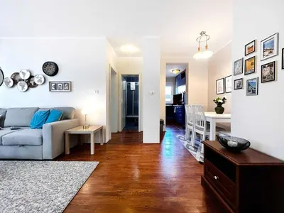 a living room with a couch and a table at Stylish 1 Bedroom Apartment Budva in Budva