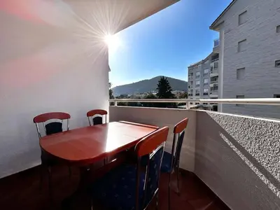a table and chairs on a balcony with a view at Stylish 1 Bedroom Apartment Budva in Budva