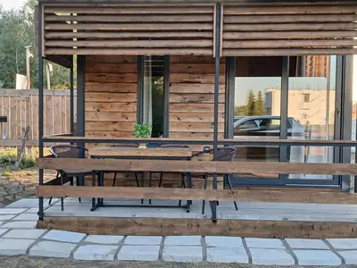 a picnic table on a patio in front of a building at Corner Bungalow in Ulcinj