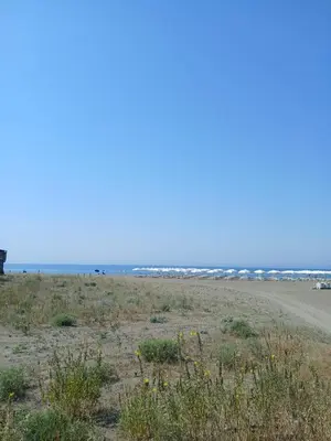 an empty beach with the ocean in the background at Corner Bungalow in Ulcinj