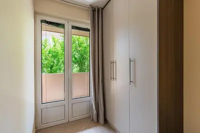 an empty room with a door and a window at Spacious Comfort in Boreti