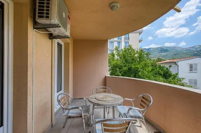 a patio with a table and chairs on a balcony at Spacious Comfort in Boreti