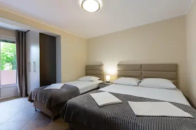 two beds in a hotel room with a window at Spacious Comfort in Boreti