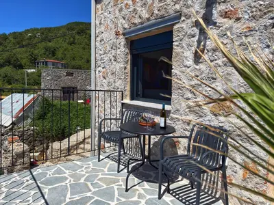 a patio with two chairs and a table on a balcony at Villa Kula apartments in Bar