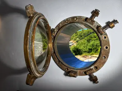a mirror hanging on a wall with a reflection at Villa Kula apartments in Bar