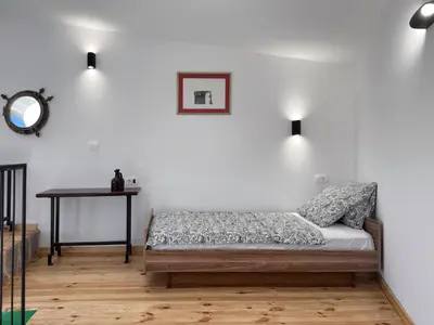 a bedroom with a bed and a table with a mirror at Villa Kula apartments in Bar