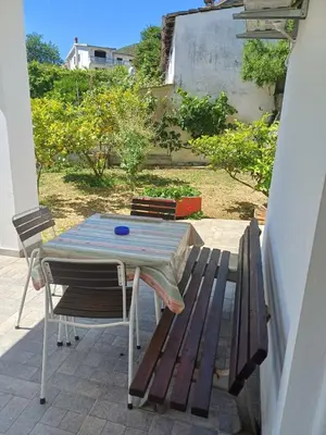 a picnic table and a bench on a patio at Apartments Ivana in Ulcinj