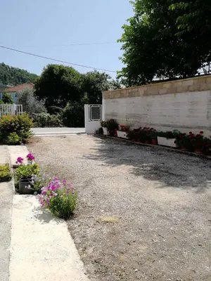 a garden with flowers on the side of a wall at Apartments Ivana in Ulcinj
