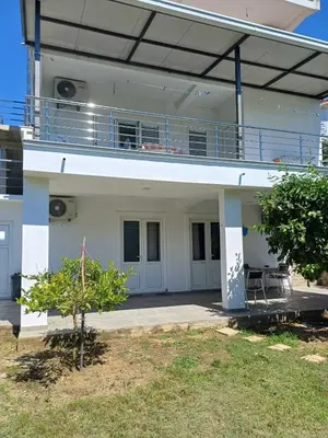 a white building with a balcony on top of it at Apartments Ivana in Ulcinj