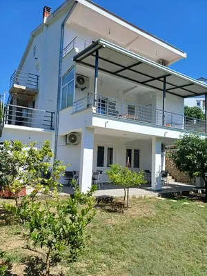 a large white building with a balcony on it at Apartments Ivana in Ulcinj