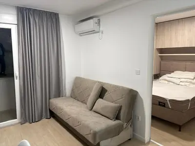 a living room with a couch and a bed at Njaro Del Mar AS in Petrovac na Moru