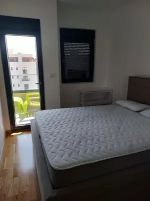 a white bed in a room with a window at Adriatic Glam in Bar