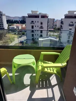 two green chairs on a balcony with a view at Adriatic Glam in Bar