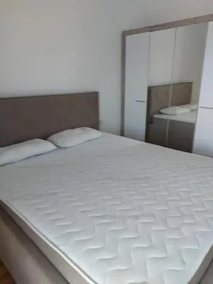 a large white bed in a room with a mirror at Adriatic Glam in Bar