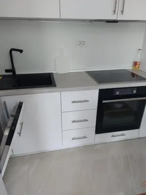 a white kitchen with a sink and a stove at Adriatic Glam in Bar