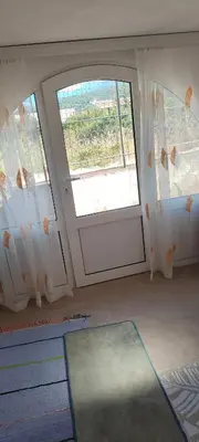 an empty room with a door and a window at Apartman Asja in Utjeha
