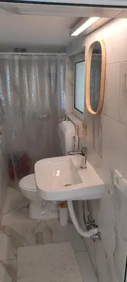 a bathroom with a sink and a toilet at Apartman Asja in Utjeha