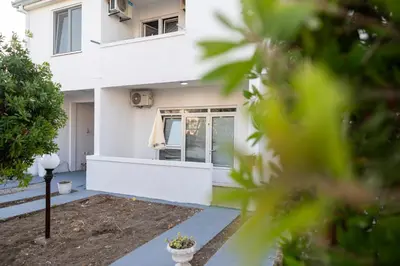 a white house with the front door open at Villa Serenita in Ulcinj