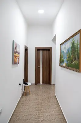 a hallway with a door and paintings on the walls at Villa Serenita in Ulcinj