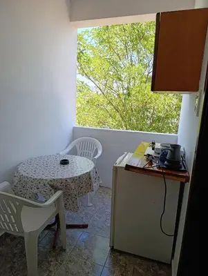 a small kitchen with a table and a window at Villa Serenita in Ulcinj