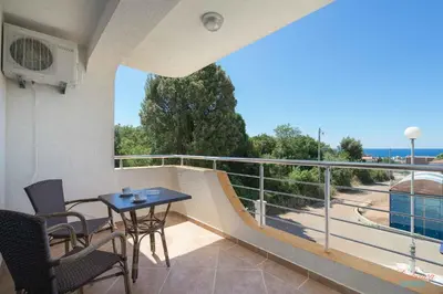 a balcony with a table and chairs and a railing at Dubrava Sea View Apartments in Dobra Voda