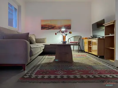 a living room with a couch and a table at Dubrava Sea View Apartments in Dobra Voda
