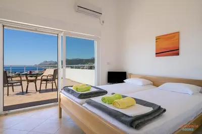 a bedroom with two beds and a view of the ocean at Dubrava Sea View Apartments in Dobra Voda
