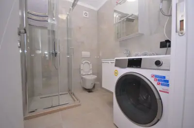 a washing machine in a bathroom with a toilet at New Studio - Dobra Voda in Dobra Voda