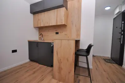 a kitchen with a counter and a chair in a room at New Studio - Dobra Voda in Dobra Voda