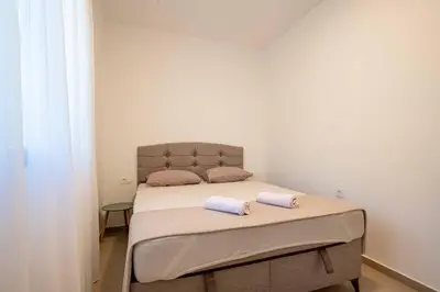 a bedroom with a bed with two towels on it at Your Adriatic Nest in Bar, Susanj