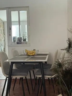 a dining room table with a bowl of bananas on it at Apartment Laganini-Bar in Bar, Susanj