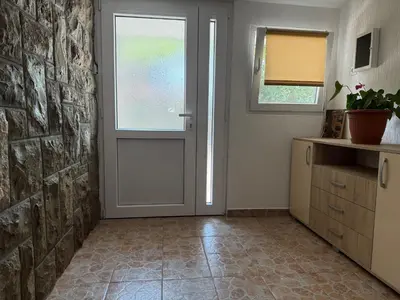 a room with a door and a window and a kitchen at Apartment Laganini-Bar in Bar, Susanj