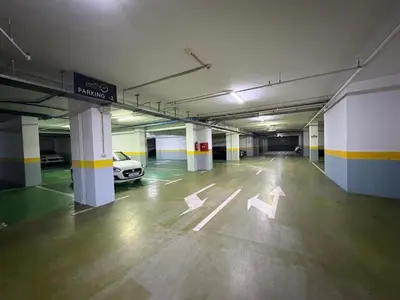 an empty parking garage with a car parked in it at Luxury penthouse in Tre Canne complex in Budva