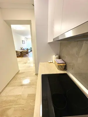 a kitchen with a black counter top in a room at Luxury penthouse in Tre Canne complex in Budva