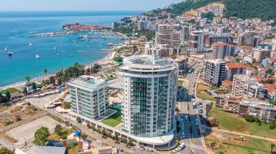 an aerial view of a city and the ocean at Luxury penthouse in Tre Canne complex in Budva