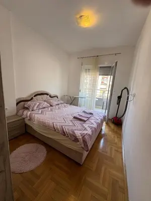 a bedroom with a bed and a window at Apartment Gardo in Budva