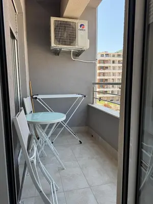 a small balcony with a table and a air conditioner at Apartment Gardo in Budva