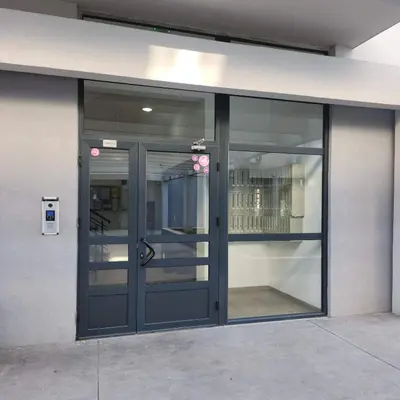 an office building with a door and windows at Stan Na Dan Podgorica Zabjelo1 in Podgorica