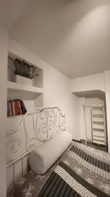 a bedroom with a white bench in a room at Villa Kotor Air in Muo