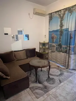a living room with a couch and a table at Riva apartman in Sutomore