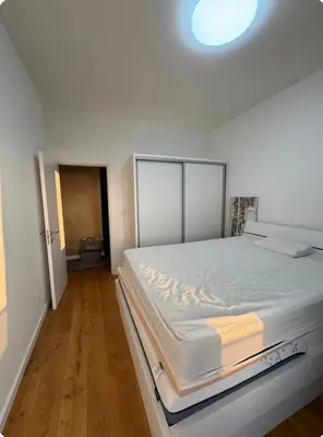 a white bedroom with a large bed in it at Soho City A in Bar