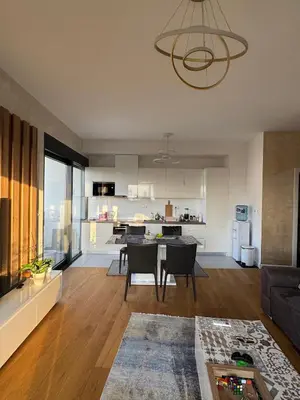 a living room and kitchen with a table and chairs at Soho City A in Bar