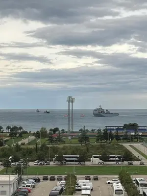 a large ship in the water with a parking lot at Soho City A in Bar