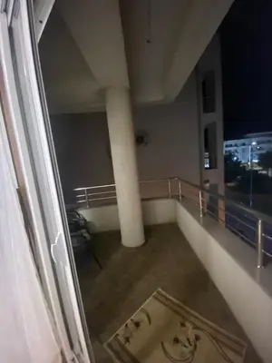 a room with a balcony with a view of the city at Pico apartments in Ulcinj