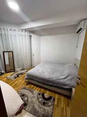 a bedroom with a bed and a rug at Pico apartments in Ulcinj